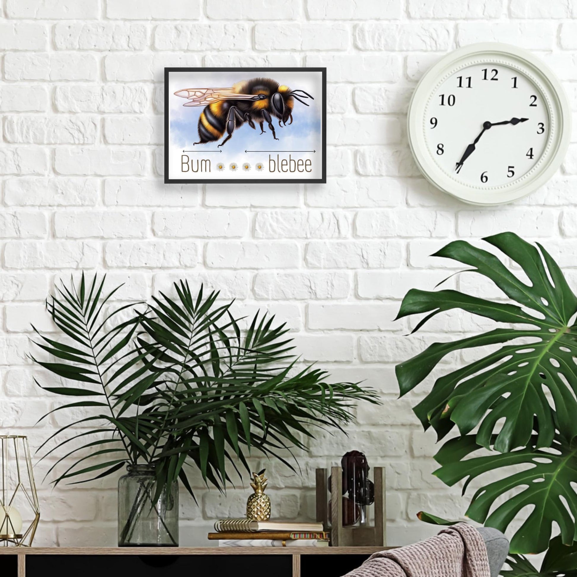 A framed A4 art print featuring a detailed illustration of a bumblebee with soft blue sky in the background. Below the bee, the text playfully reads "Bum" followed by five daisy icons and then "blebee," with arrows pointing across the entire phrase to emphasise the humorous, stretched-out pun
