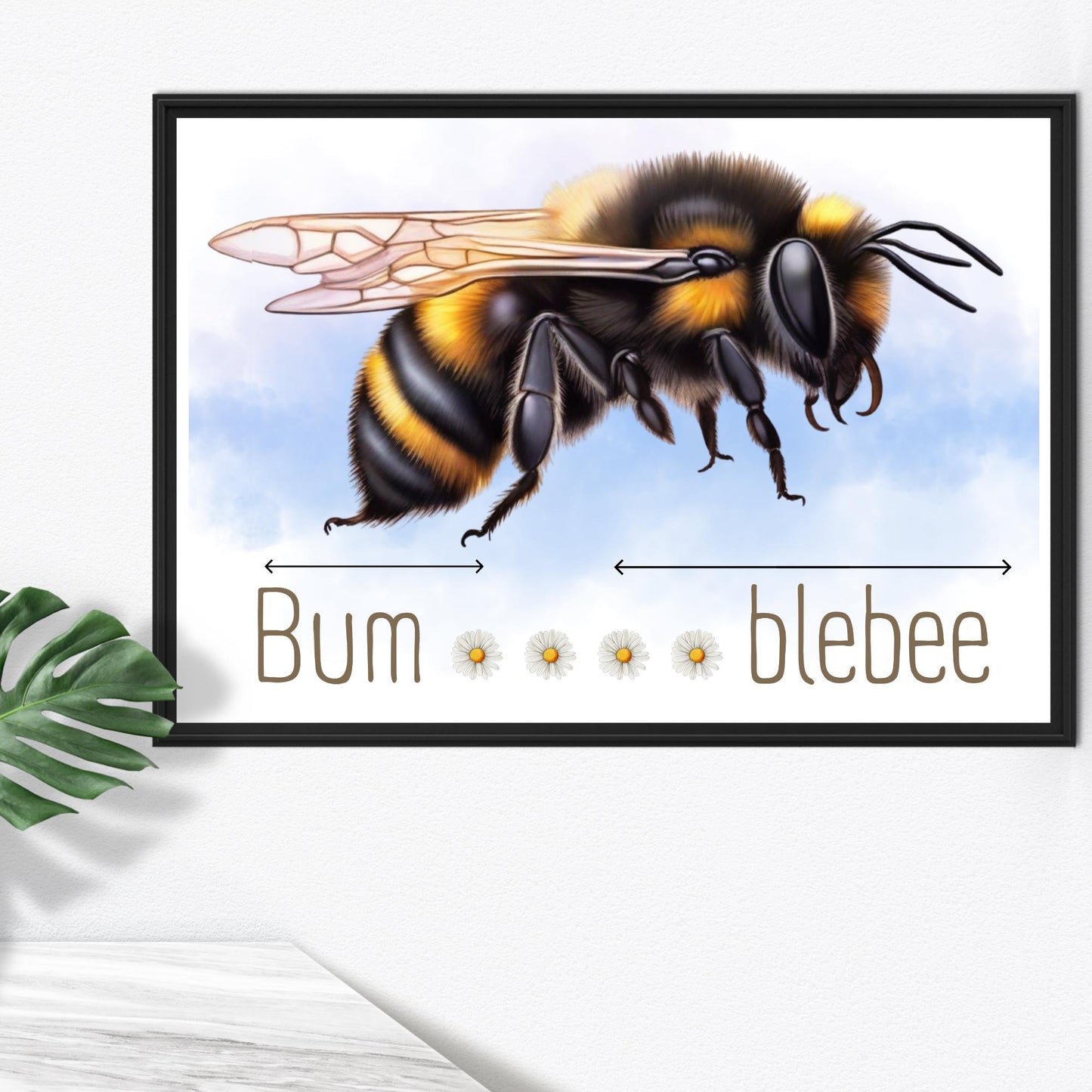 A framed A4 art print featuring a detailed illustration of a bumblebee with soft blue sky in the background. Below the bee, the text playfully reads "Bum" followed by five daisy icons and then "blebee," with arrows pointing across the entire phrase to emphasise the humorous, stretched-out pun