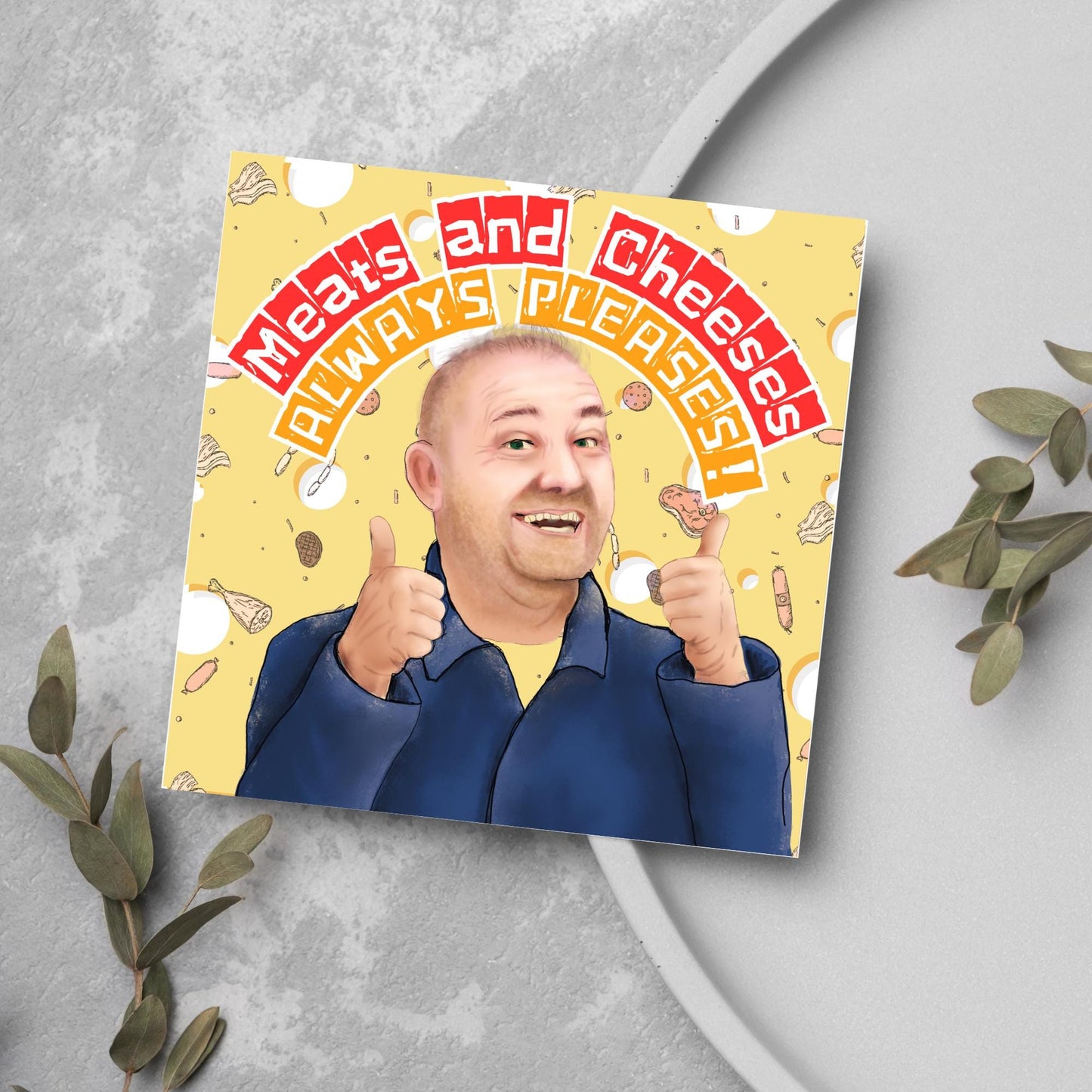 Square greeting card with a hand drawn image of Bob MOrtimer with 2 thumbs up against a backdrop of swiss cheese and various illustrations of different types of meat, with arched text that reads 'meats and cheeses always pleases'