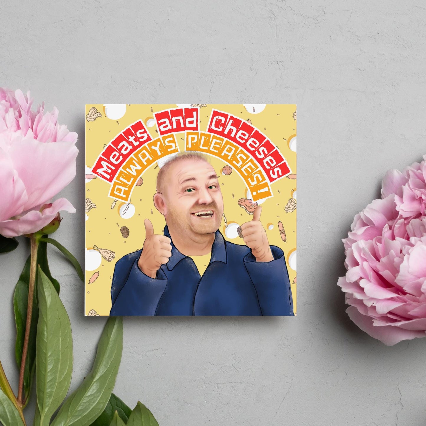 Square greeting card with a hand drawn image of Bob MOrtimer with 2 thumbs up against a backdrop of swiss cheese and various illustrations of different types of meat, with arched text that reads 'meats and cheeses always pleases'