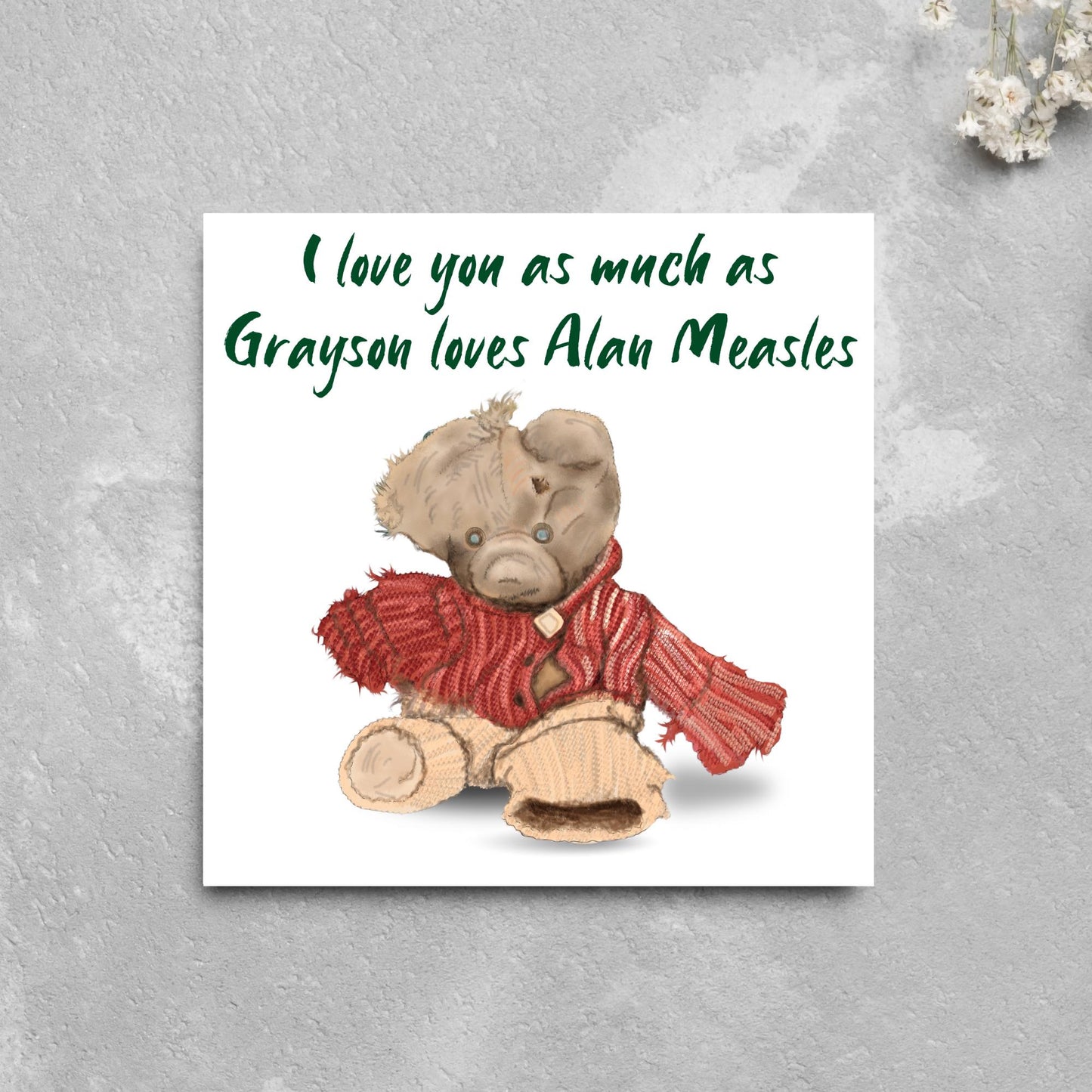 This is an image of a square anniversary card with a hand drawn illustration of Grayson Perry's beloved Alan Measels teddy bear with hand written style that says 'I love you as much as Grayson loves Alan Measels'.