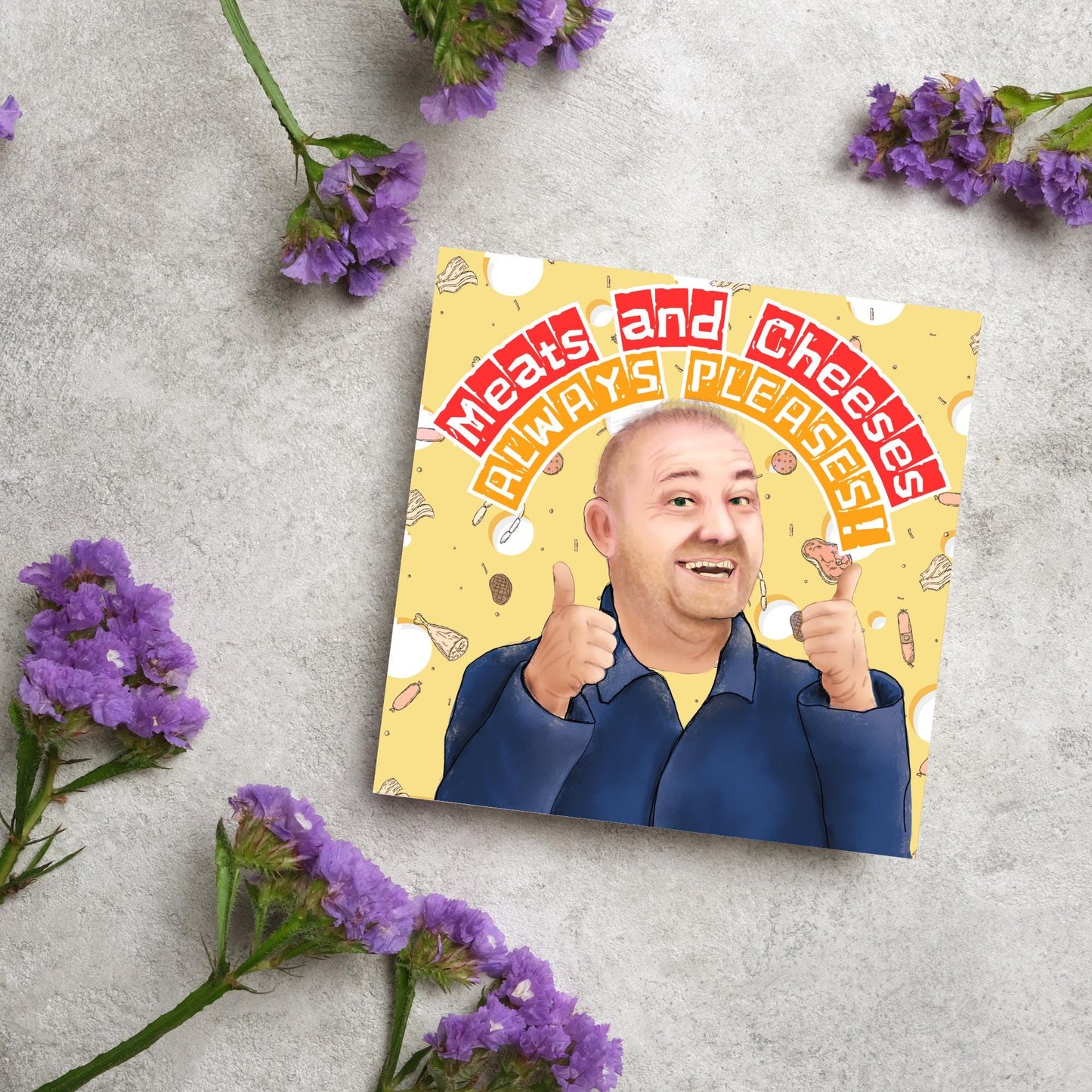 Square greeting card with a hand drawn image of Bob MOrtimer with 2 thumbs up against a backdrop of swiss cheese and various illustrations of different types of meat, with arched text that reads 'meats and cheeses always pleases'