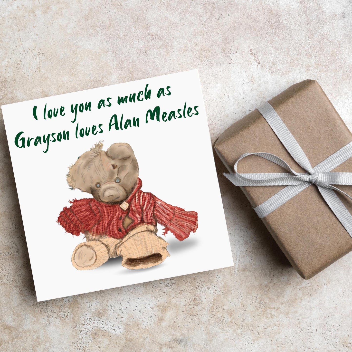 This is an image of a square anniversary card with a hand drawn illustration of Grayson Perry's beloved Alan Measels teddy bear with hand written style that says 'I love you as much as Grayson loves Alan Measels'.