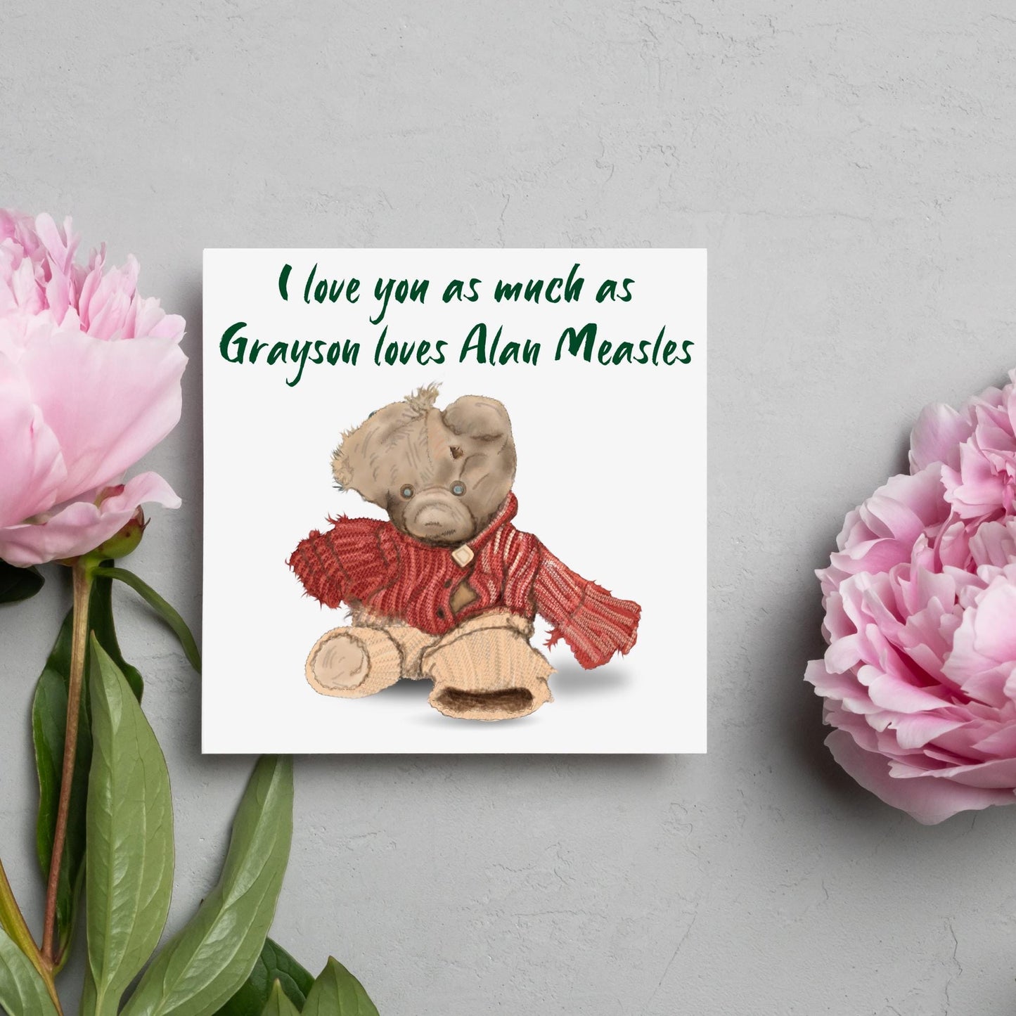 This is an image of a square anniversary card with a hand drawn illustration of Grayson Perry's beloved Alan Measels teddy bear with hand written style that says 'I love you as much as Grayson loves Alan Measels'.