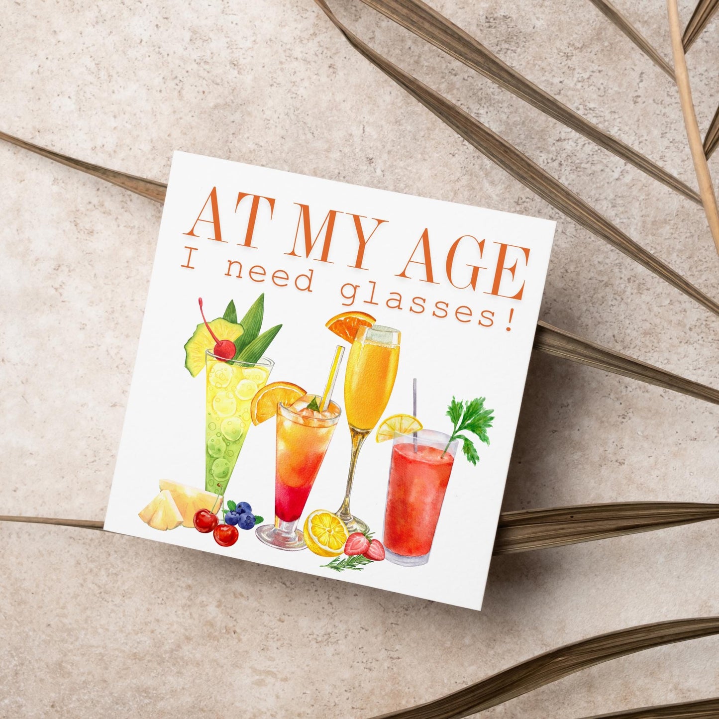 Image of a square birthday card with colourful illustrations of cocktails with the text - at my age I need glasses!