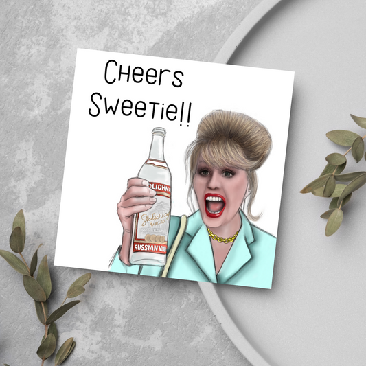 Image of a square greetings card against a grey background. The design is an illustration of Patsy Stone Holding a bottle of vodka with the text cheers sweetie!!