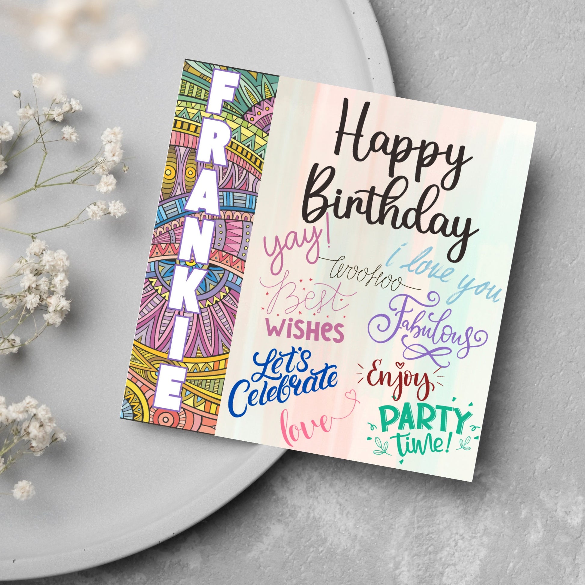 Square birthday card with bold patterned edge with the recipients name overlaid in white. the rest of the card says happy birthday over a pastel background, with messages of yay, I love you, woohoo, best wishes, lets celebrate, enjoy, party time