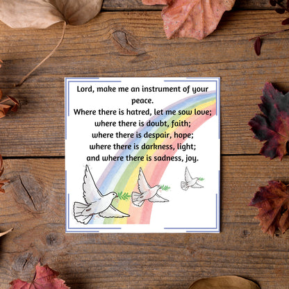 Square greetings card with 3 flying peace doves against a rainbow, with the Prayer of Saint Francis text Lord, make me an instrument of your peace.