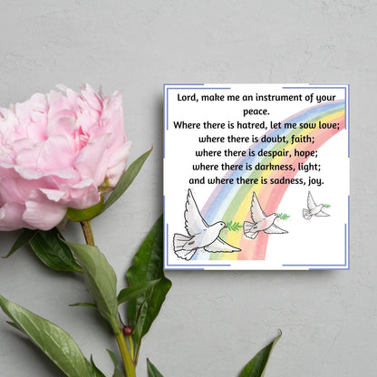Square greetings card with 3 flying peace doves against a rainbow, with the Prayer of Saint Francis text Lord, make me an instrument of your peace.