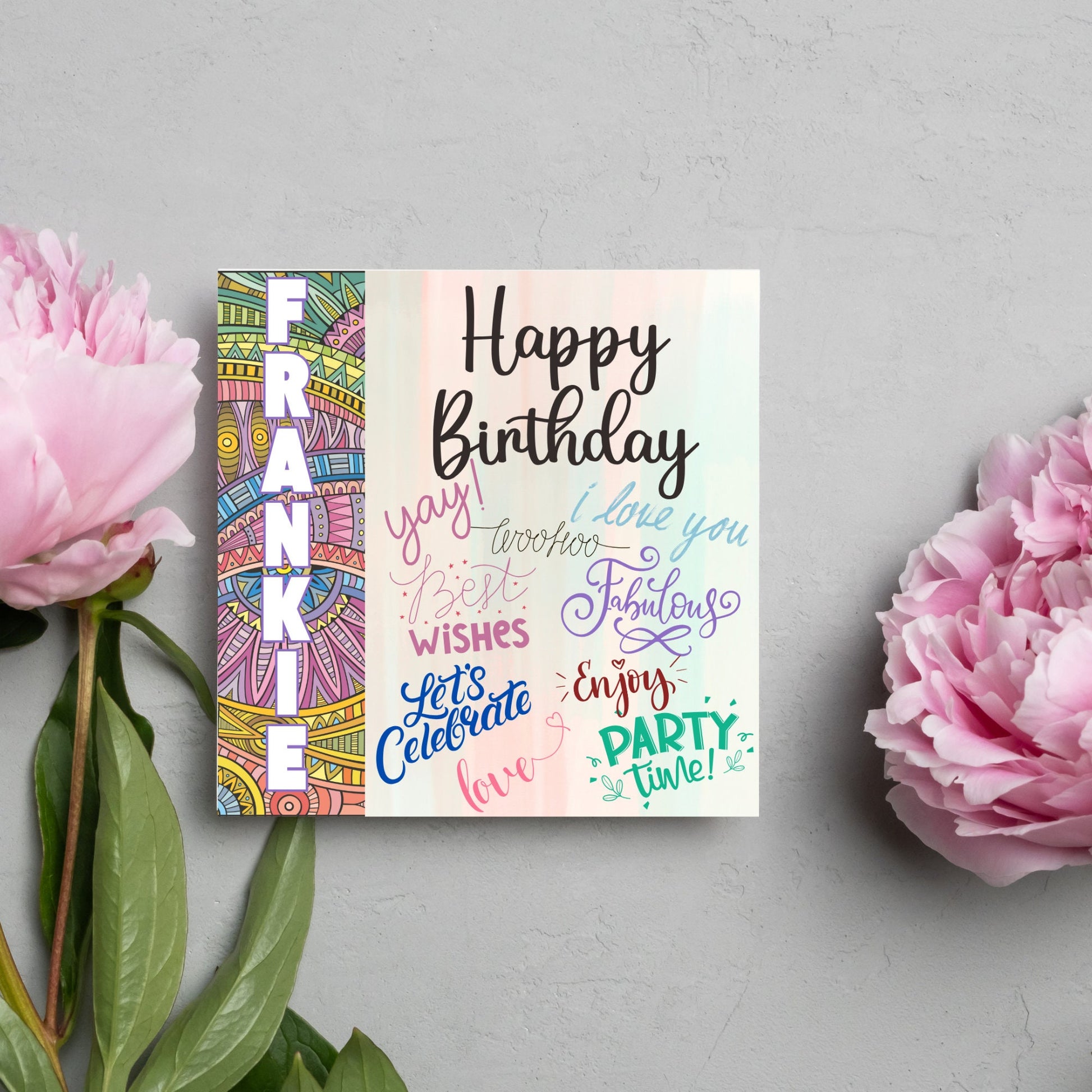 Square birthday card with bold patterned edge with the recipients name overlaid in white. the rest of the card says happy birthday over a pastel background, with messages of yay, I love you, woohoo, best wishes, lets celebrate, enjoy, party time