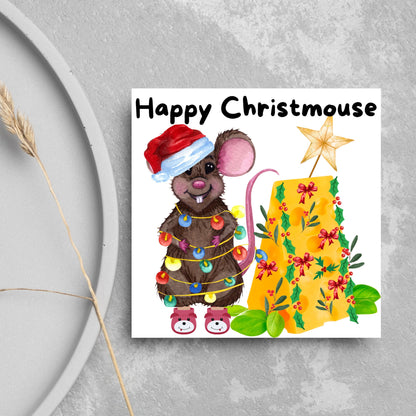 Square Christmas card featuring a cartoon mouse wrapped in christmas lights and wearing a santa hat and slippers next to a christmas tree made from cheese with decorations of holly and red bows. The text, Happy Christmouse is written at the top