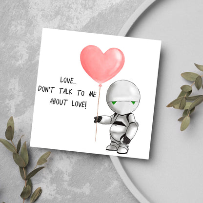 The Square Card has an illistration of Marvin from the classic book, a Hitchhikers guide to the galaxy holding a heart shaped Balloon. It is accompanied by the caption &quot;Love, dont talk to me about Love!&quot;
Funny Love card for boyfriends