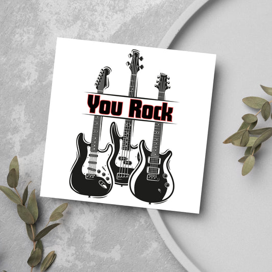 Square Greetings card featuring 3 black electric guitars with &#39;you rock&#39; written across them in red and black