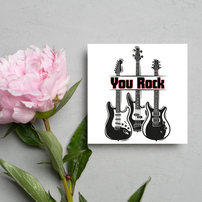 Square Greetings card featuring 3 black electric guitars with &#39;you rock&#39; written across them in red and black