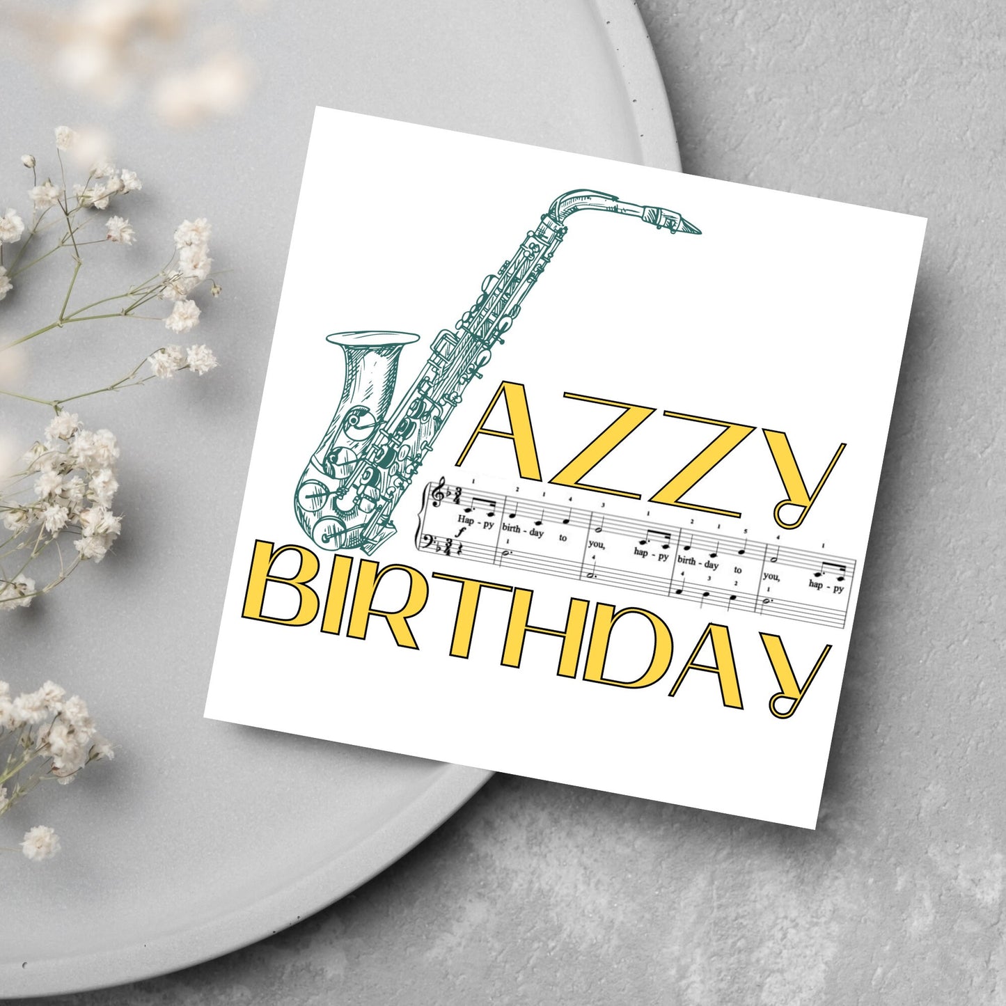 The Birthday Card has an image of a saxaphone in the shape of a &#39;J&#39; along with the word have a Jazzy Birthday. The Card depicts a music sheet of Happy Birthday. This Card is ideal for musicians