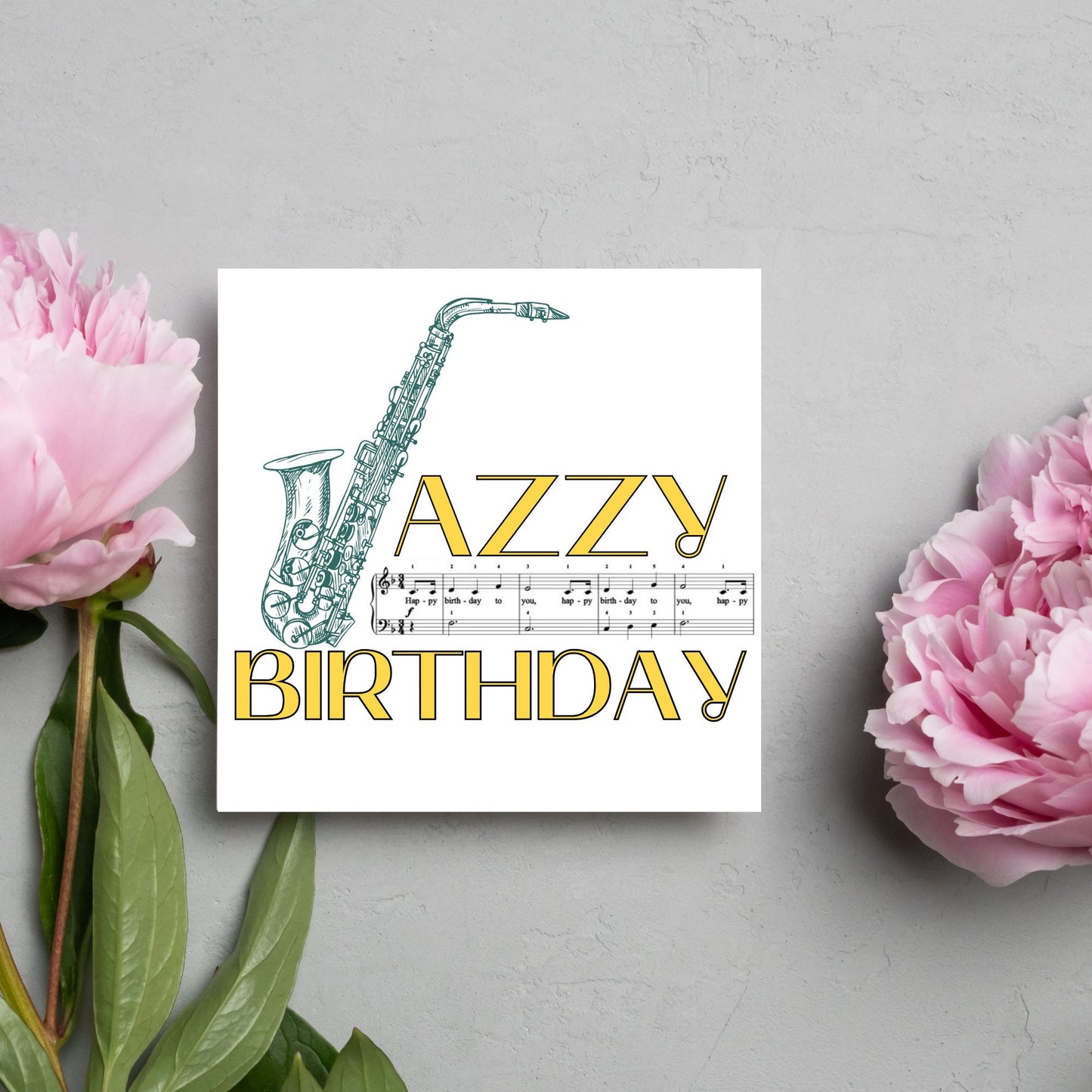 The Birthday Card has an image of a saxaphone in the shape of a &#39;J&#39; along with the word have a Jazzy Birthday. The Card depicts a music sheet of Happy Birthday. This Card is ideal for musicians