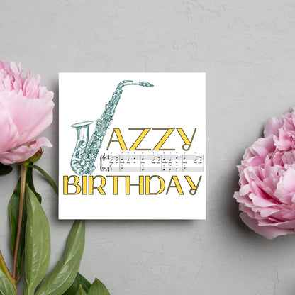 The Birthday Card has an image of a saxaphone in the shape of a &#39;J&#39; along with the word have a Jazzy Birthday. The Card depicts a music sheet of Happy Birthday. This Card is ideal for musicians