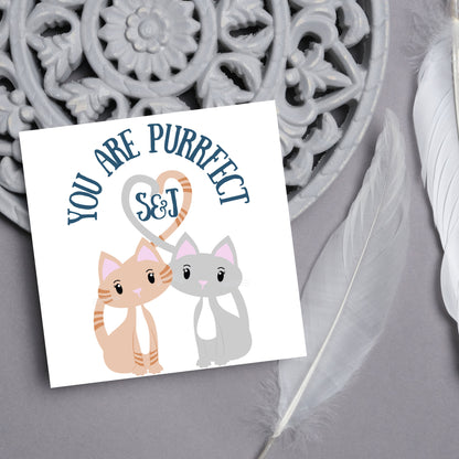 The Square Card has two cute illistration of cats with tails which lock to form a heart shape. Inside the heart is the personalisable initals of your loved one. The card reads &#39;You are Purrfect&#39;. This anniversary/valentines day card is cute