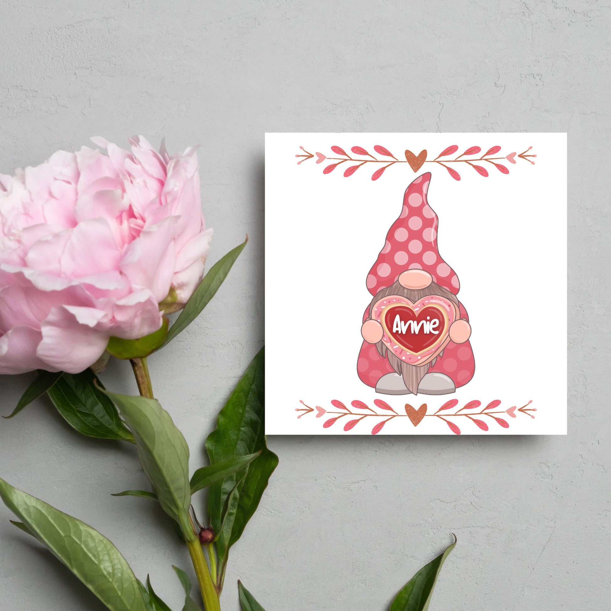 The Square Card has a cute gonk holding a love heart with a perssonalised name, the card has a cute heart header and footer, The Card is a cute representation of love, The Card is perfect for your valentines