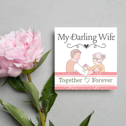 The Card has an illistration of a married couple holding hands. The Caption Reads &#39;My Darling Wife - Together Forever&#39;. The Card is printed in pastel tones and is perfect for anniversaries or valentines day.