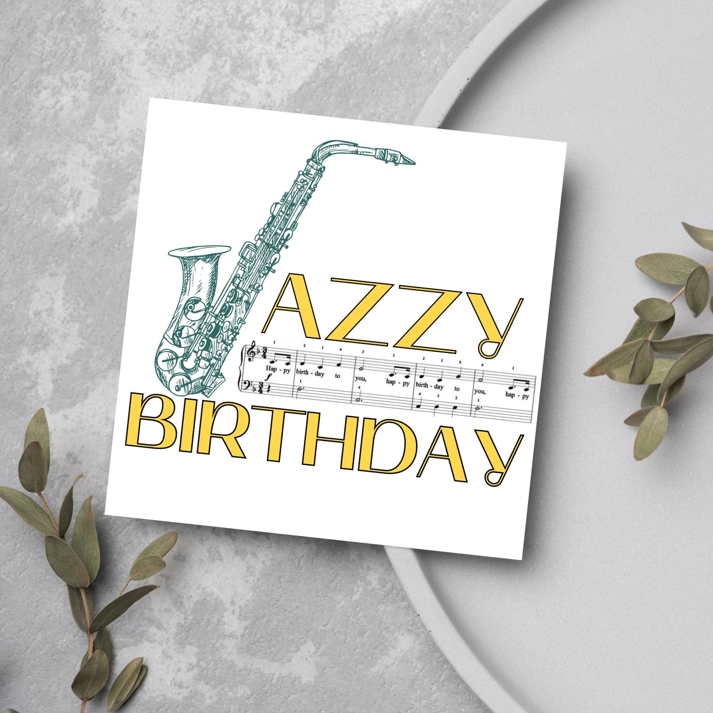 The Birthday Card has an image of a saxaphone in the shape of a &#39;J&#39; along with the word have a Jazzy Birthday. The Card depicts a music sheet of Happy Birthday. This Card is ideal for musicians