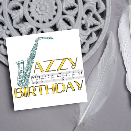 The Birthday Card has an image of a saxaphone in the shape of a &#39;J&#39; along with the word have a Jazzy Birthday. The Card depicts a music sheet of Happy Birthday. This Card is ideal for musicians