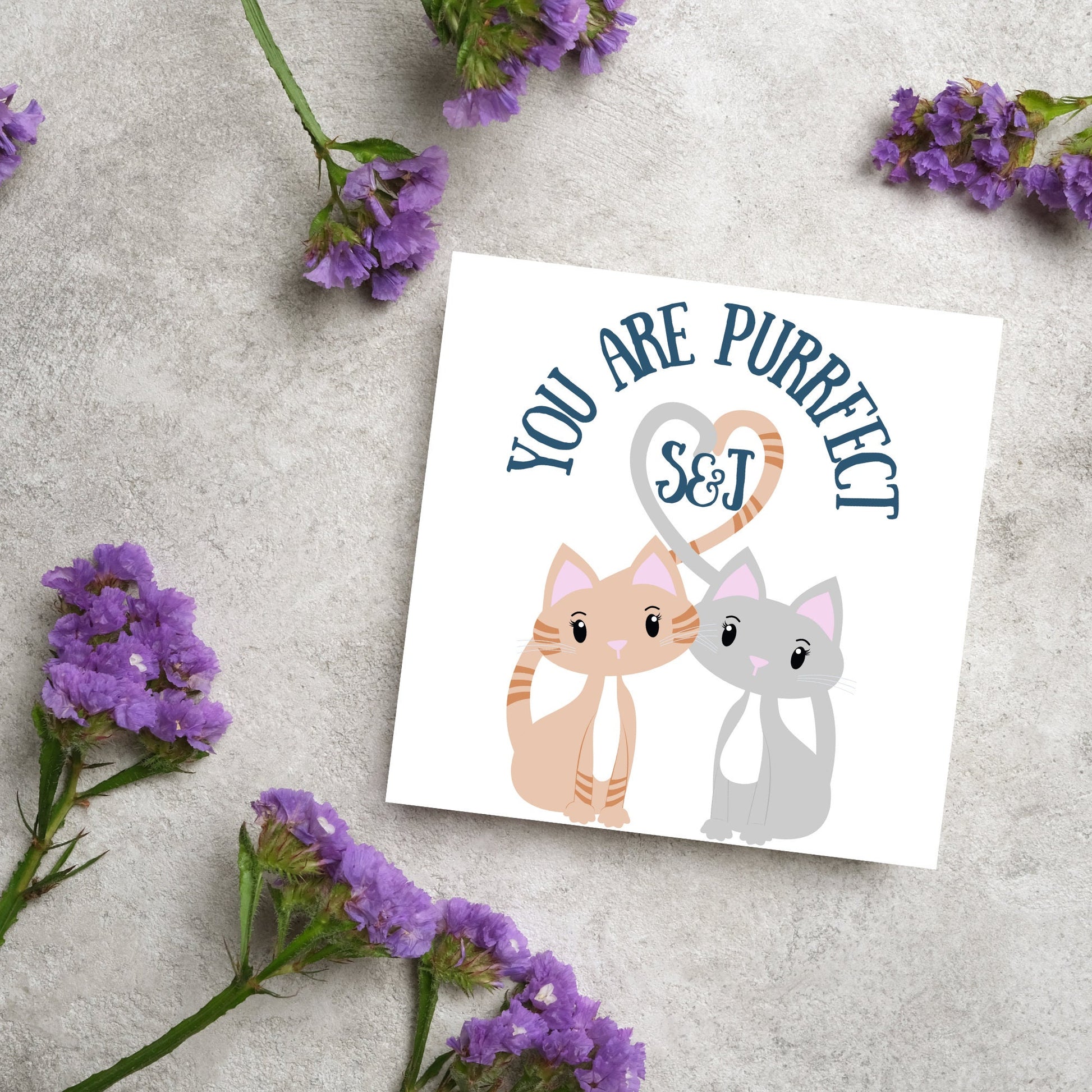 The Square Card has two cute illistration of cats with tails which lock to form a heart shape. Inside the heart is the personalisable initals of your loved one. The card reads &#39;You are Purrfect&#39;. This anniversary/valentines day card is cute