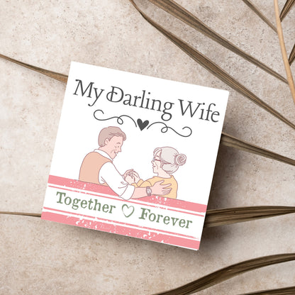 The Card has an illistration of a married couple holding hands. The Caption Reads &#39;My Darling Wife - Together Forever&#39;. The Card is printed in pastel tones and is perfect for anniversaries or valentines day.