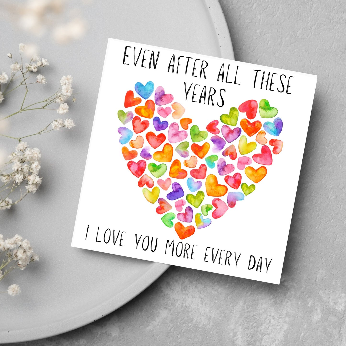 square card with colourful watercolour hearts making one big heart and the text &#39;even after all these years, i love you more everyday&#39; in a handwritten style font
