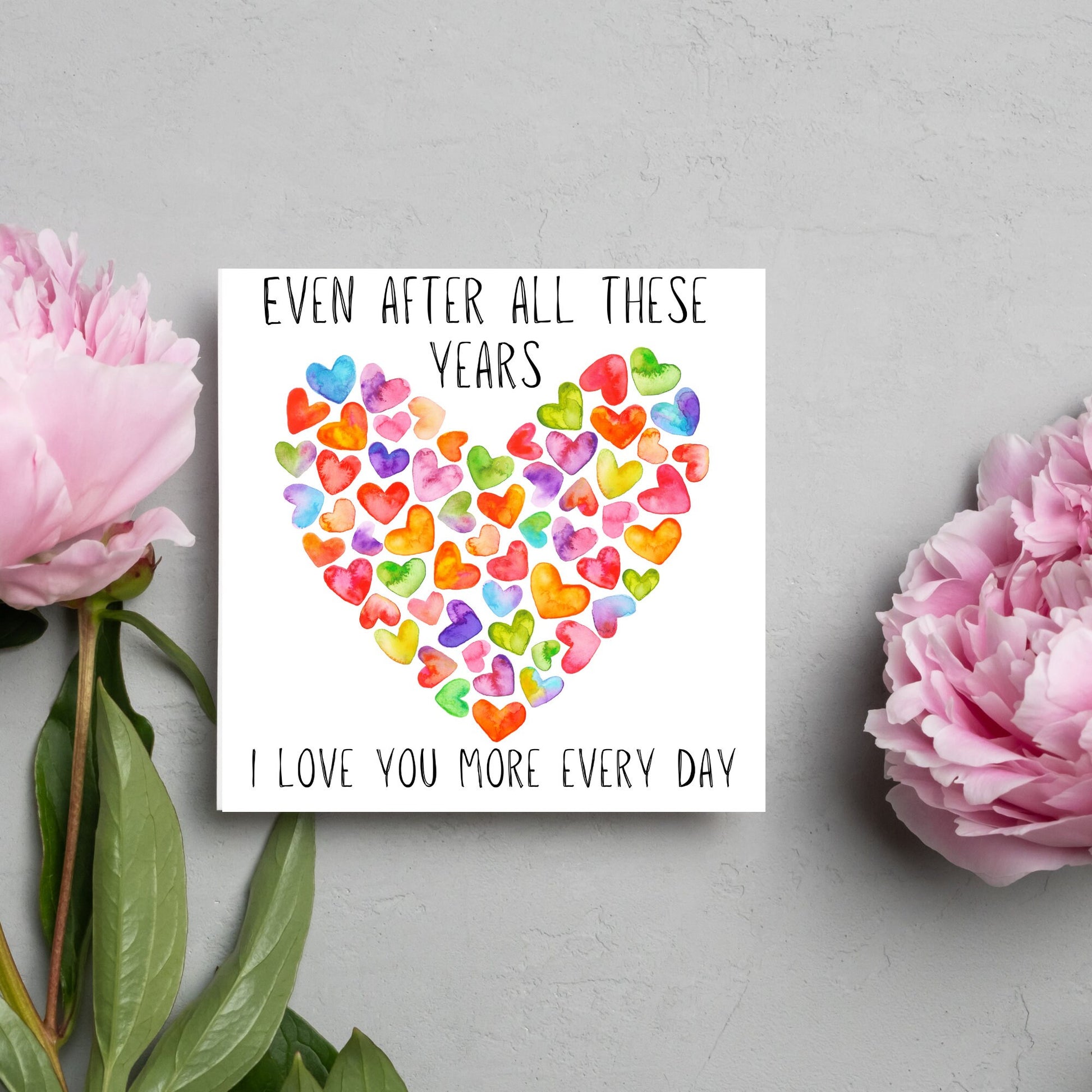 square card with colourful watercolour hearts making one big heart and the text &#39;even after all these years, i love you more everyday&#39; in a handwritten style font