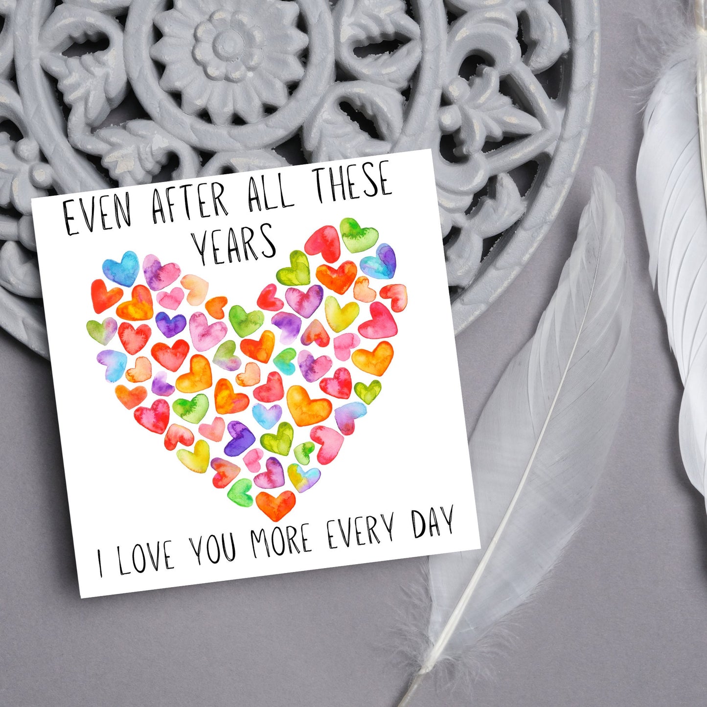 square card with colourful watercolour hearts making one big heart and the text &#39;even after all these years, i love you more everyday&#39; in a handwritten style font