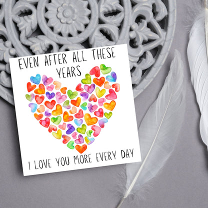 square card with colourful watercolour hearts making one big heart and the text &#39;even after all these years, i love you more everyday&#39; in a handwritten style font