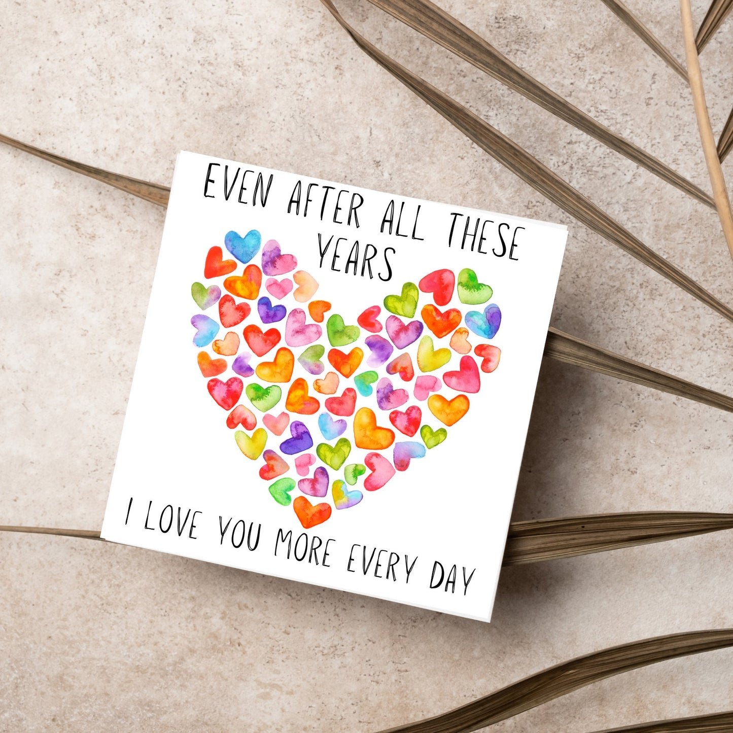 square card with colourful watercolour hearts making one big heart and the text &#39;even after all these years, i love you more everyday&#39; in a handwritten style font