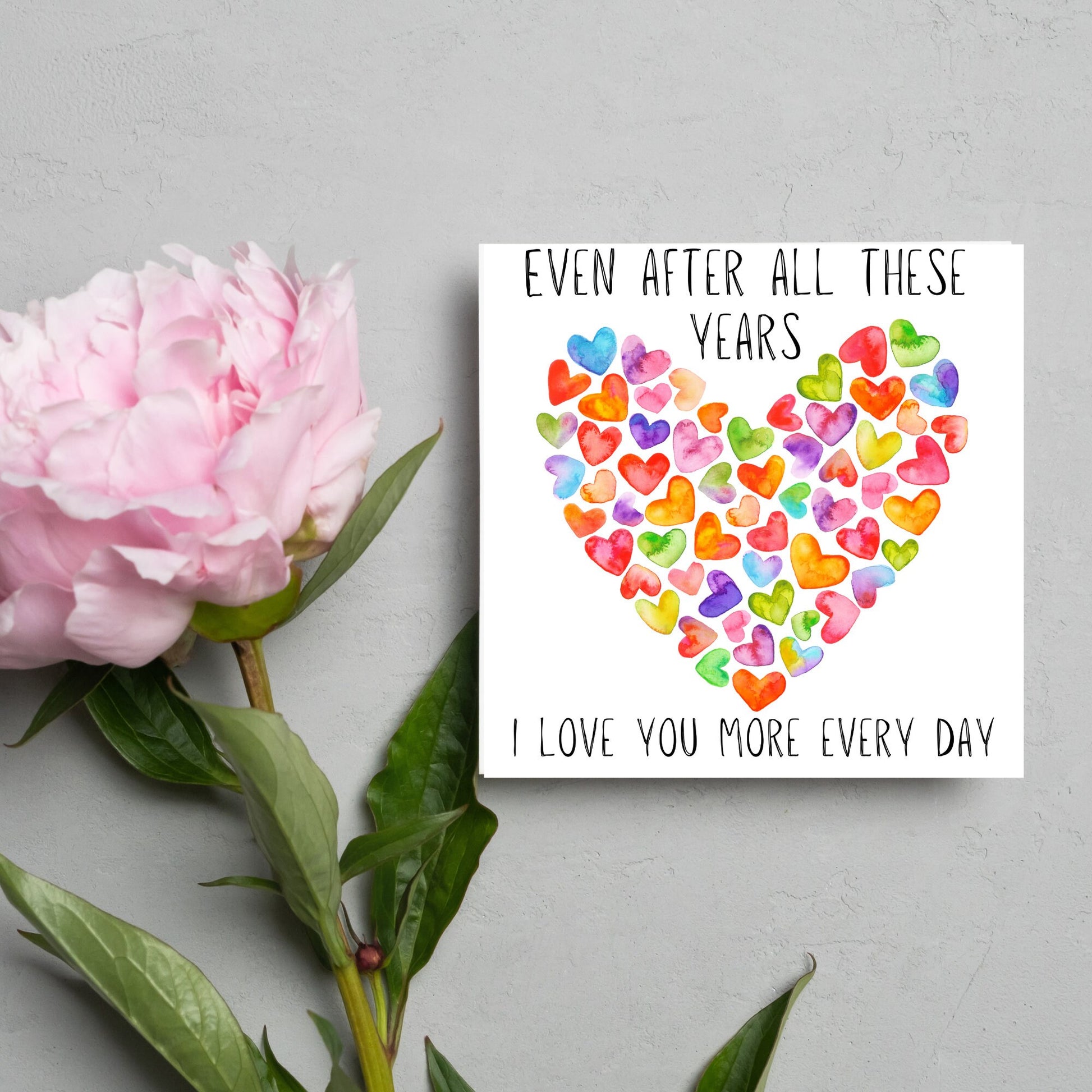 square card with colourful watercolour hearts making one big heart and the text &#39;even after all these years, i love you more everyday&#39; in a handwritten style font