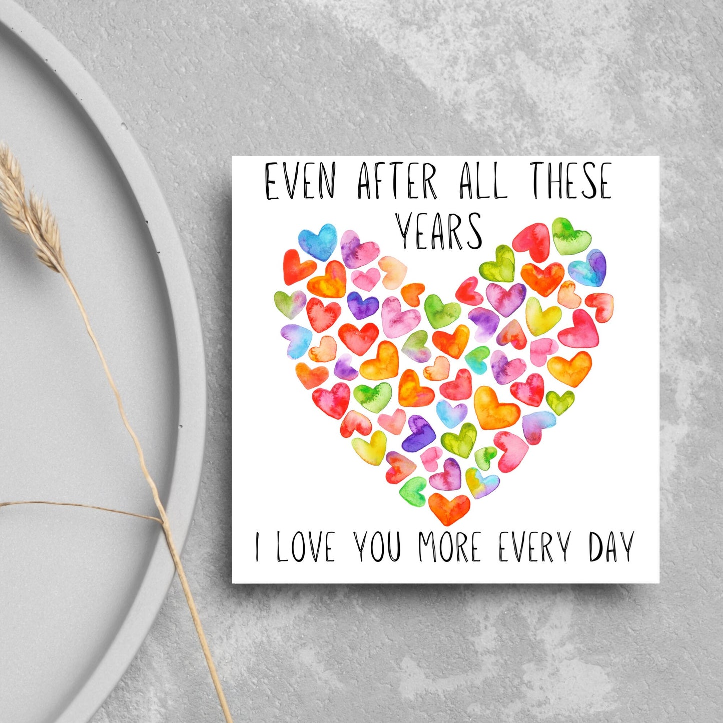 square card with colourful watercolour hearts making one big heart and the text &#39;even after all these years, i love you more everyday&#39; in a handwritten style font