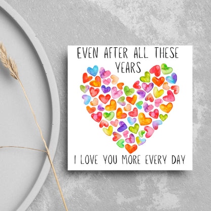 square card with colourful watercolour hearts making one big heart and the text &#39;even after all these years, i love you more everyday&#39; in a handwritten style font