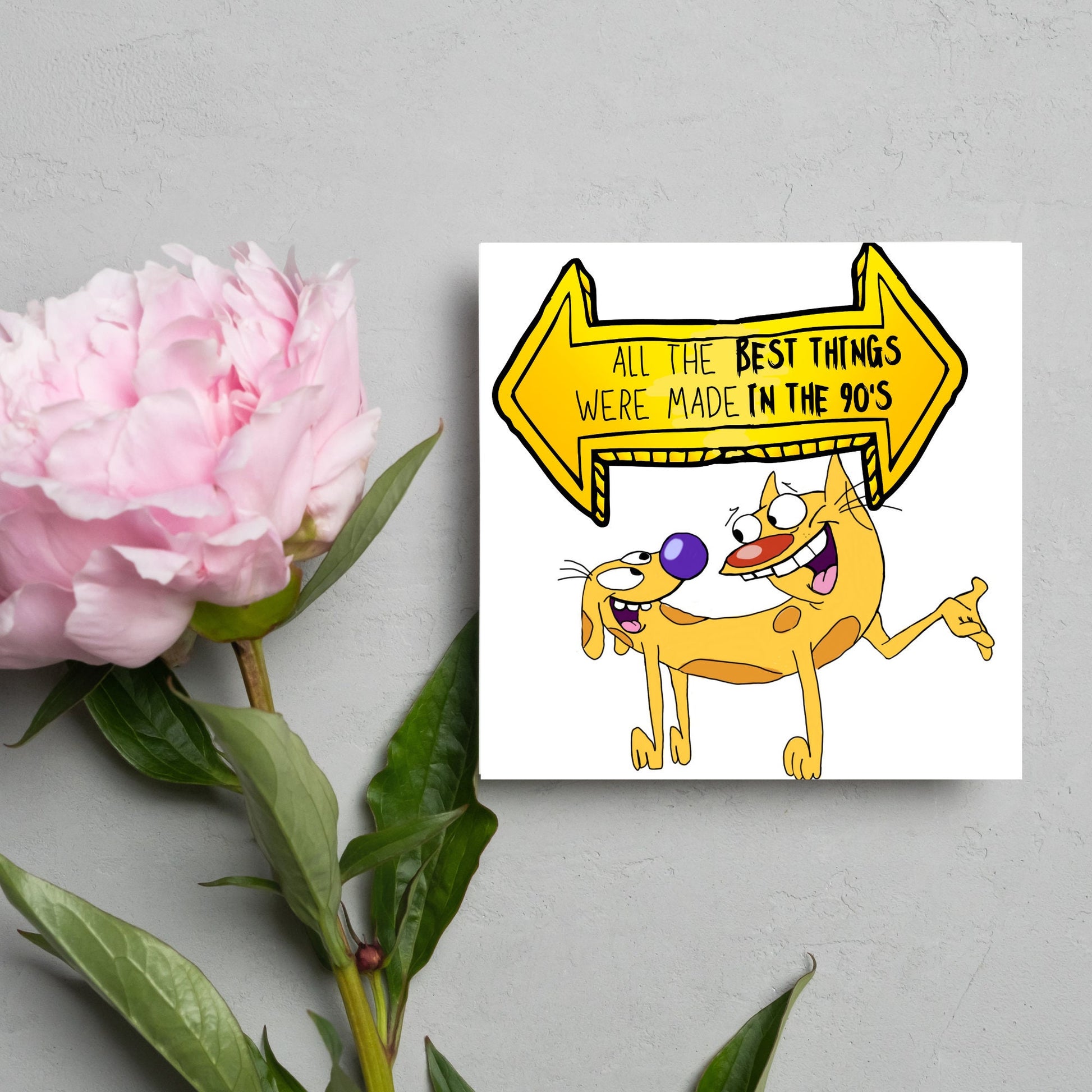 square card featuring an illustration of catdog with a yellow and black sign above them with the text that reads  &#39;all the best things were&#39; made in the 90&#39;s&#39; in the font from the shows title