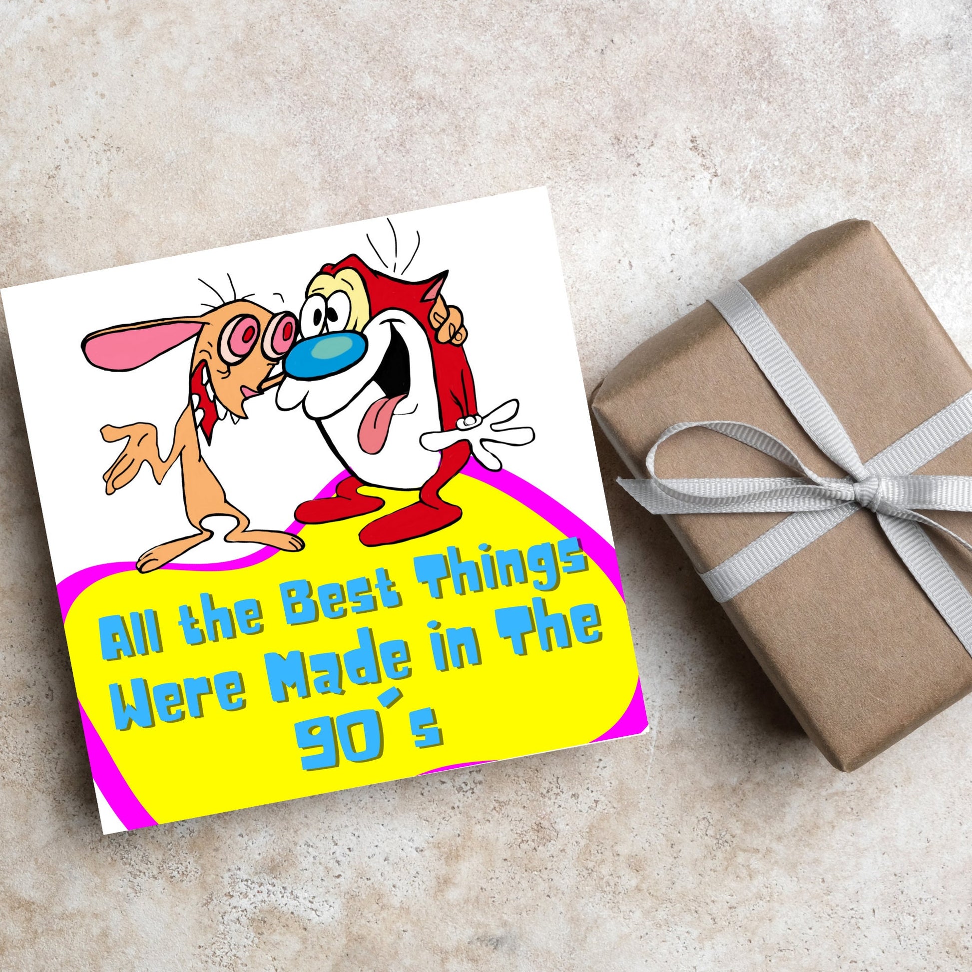square card featuring an illustration of Ren and Stimpy arm in arm with blue pink and yellow text that reads  &#39;all the best things were&#39; made in the 90&#39;s&#39; in the font from the shows title