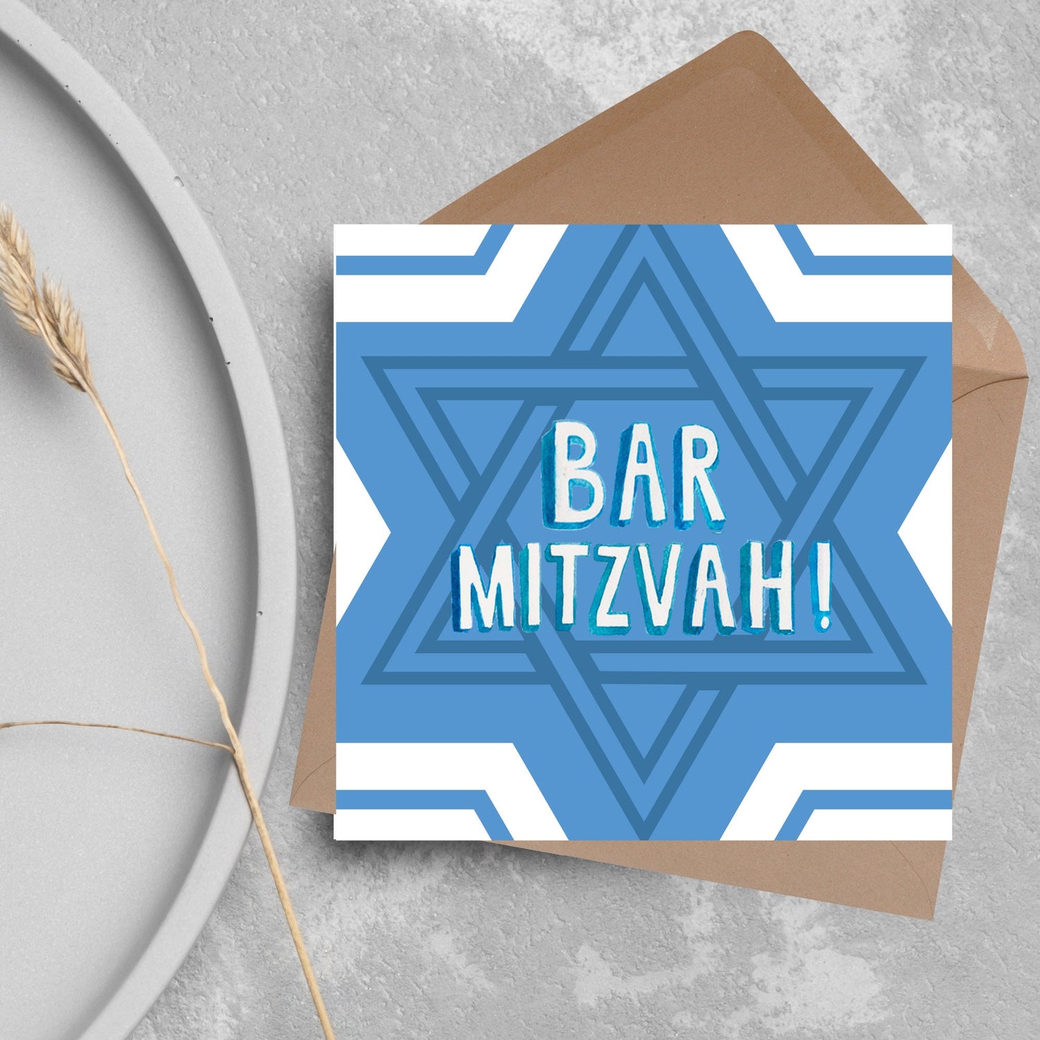 white and blue bar mitzvah card, geometric design with a repeating star of david at the centre in various shades of blue. At the centre of the card in white writing are the words &#39;bar mitzvah!&#39; in capital letters in a handwritten style font