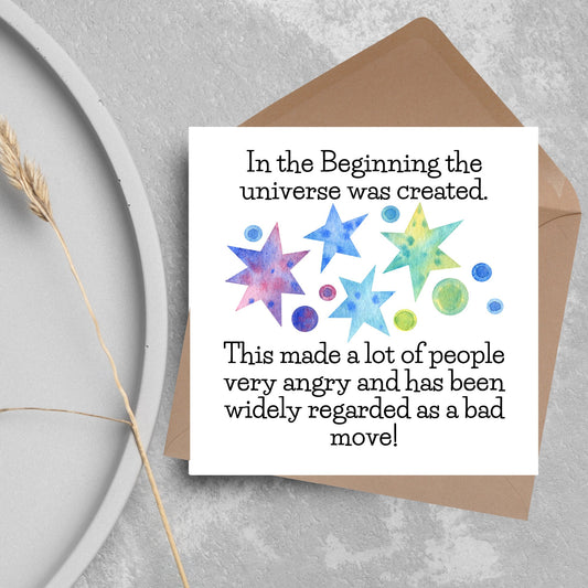 square card with watercolour abstract stars and planets and the text - in the beginning the universe was created. This made a lot of people very angry and has been widely regarded as a bad move! from the hitchhikers guide to the galaxy