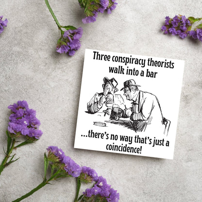Image of a square greetings card with a hand drawn black and white line cartoon sketch of two old men at a bar drinking beer with the text- 3 conspiracy theorists walk into a bar....there&#39;s no way that&#39;s just a coincidence!