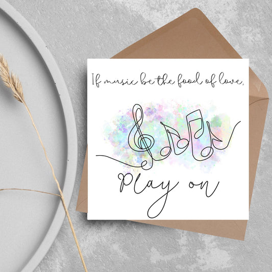 White square card with a one line drawing of musical notes that look like they are dancing in front of a pastel rainbow watercolour cloud. Cursive text reads, If music be the food of love, play on