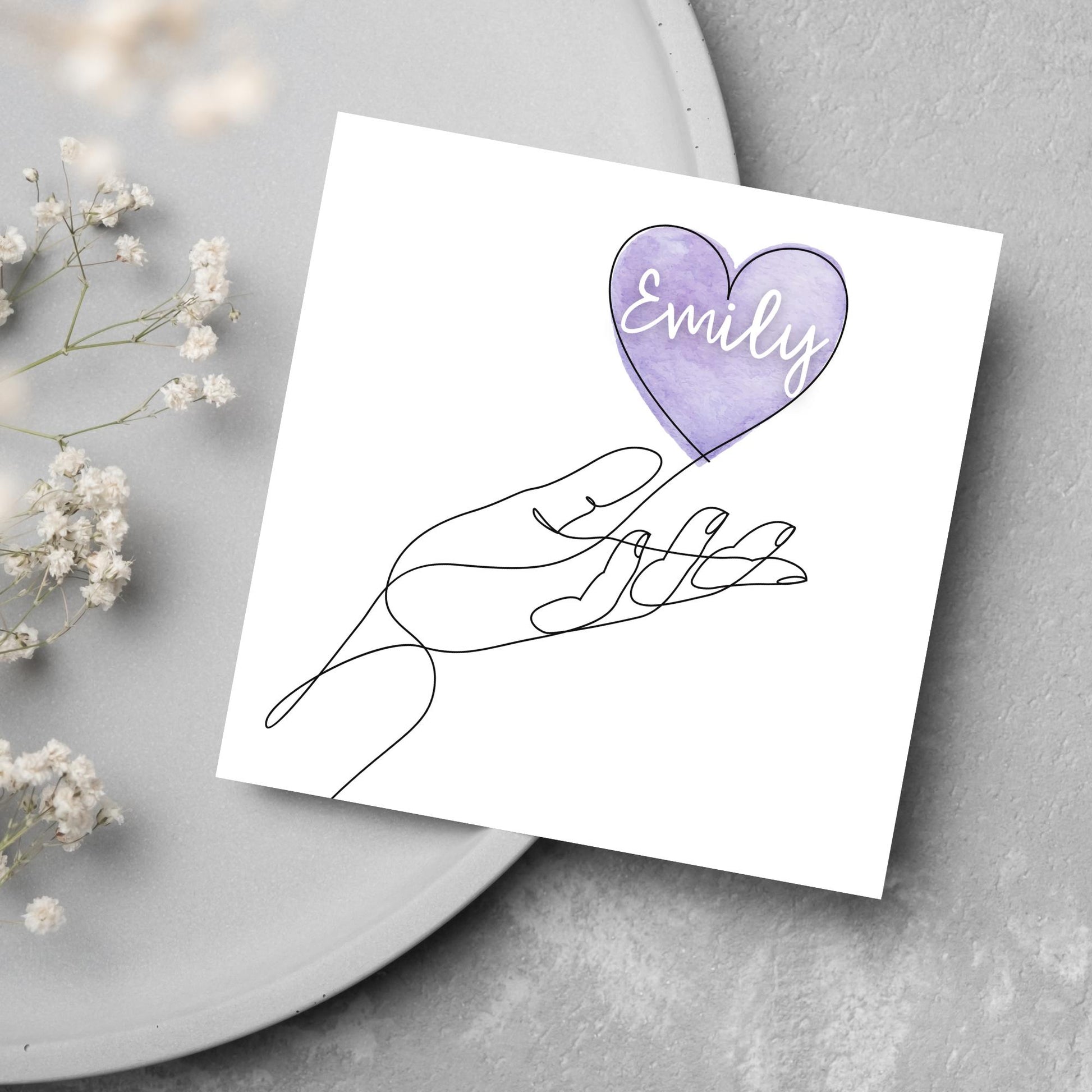 square card with a simple black and white one line drawing of an open hand with a heart rising from the hand. the heart has a purple background and has a personalised name written in a white cursive text