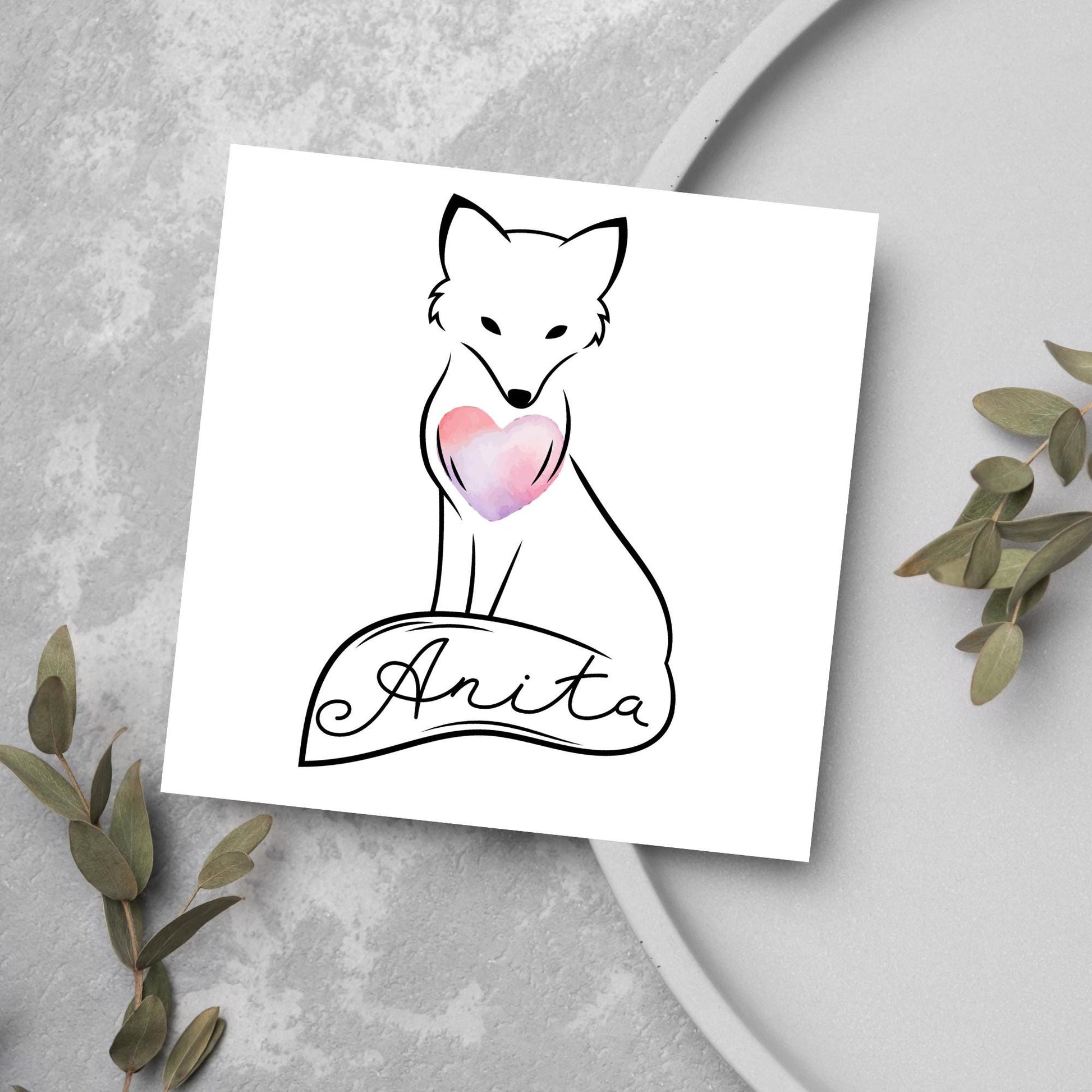 Square card with simple black line drawing of a fox  sitting with its tail wrapped around its feet. It has a pink watercolour heart on its chest and personalised with a name on the tail in a calligraphy font