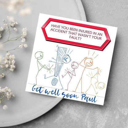 Square Get well soon card with a red sign which says have you been injured in an accident that wasn&#39;t your fault? above stick person cartoons of various injuries. Underneath is a handwritten style message that reads get well soon paul