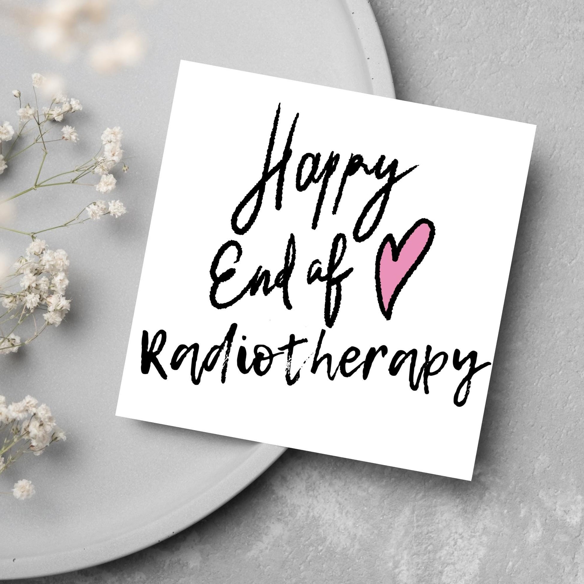 Simple square card with a white backdrop and black handwritten style text that reads HAPPY END OF RADIOTHERAPY with a roughly drawn pink heart next to the text.