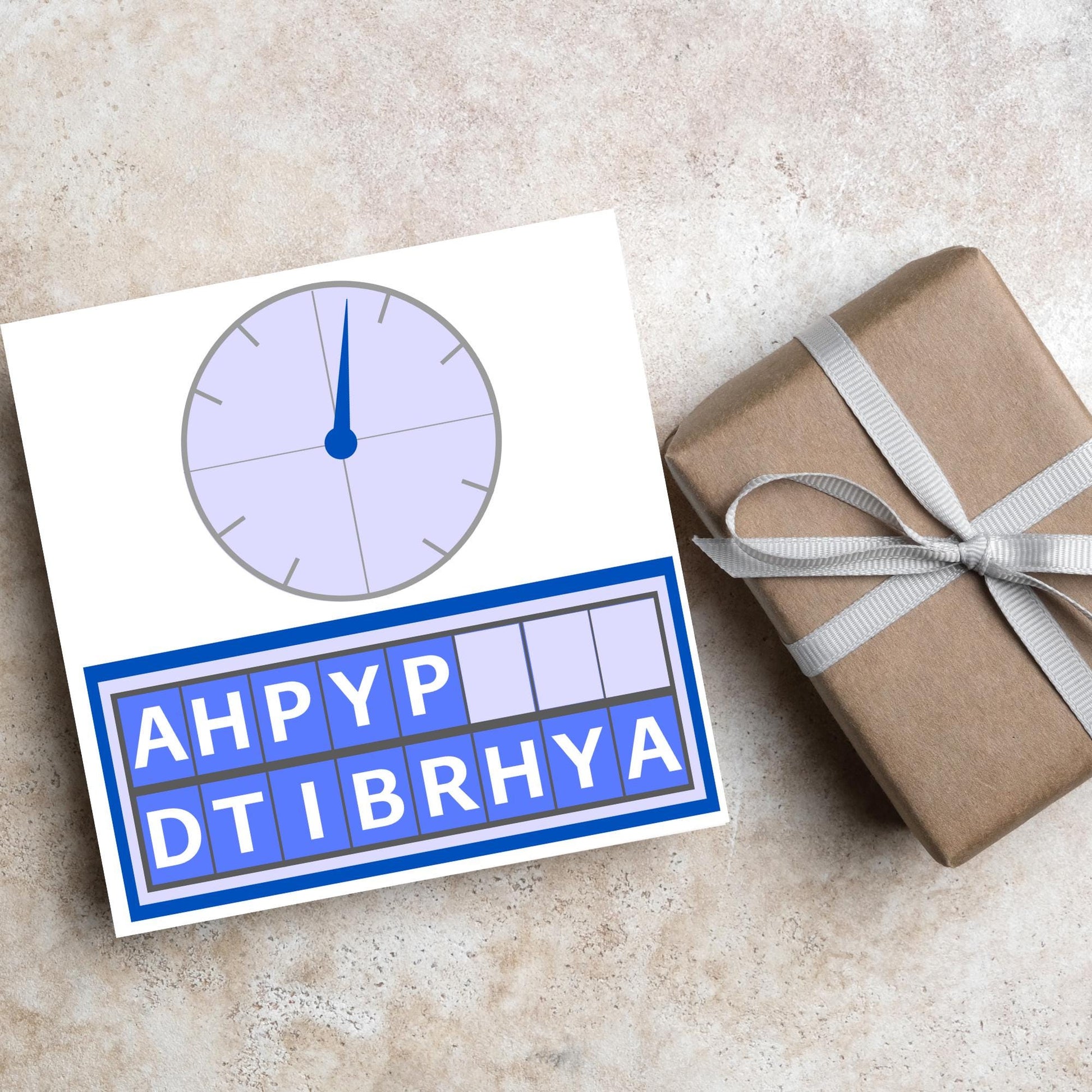 Square birthday card with a countdown theme with the clock and jumbled up letters that spell happy birthday