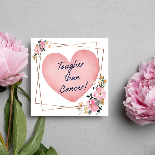 Square white card with a watercolour floral border frame and a pink heart in the centre with the text Tougher than cancer in s handwritten style navy blue font