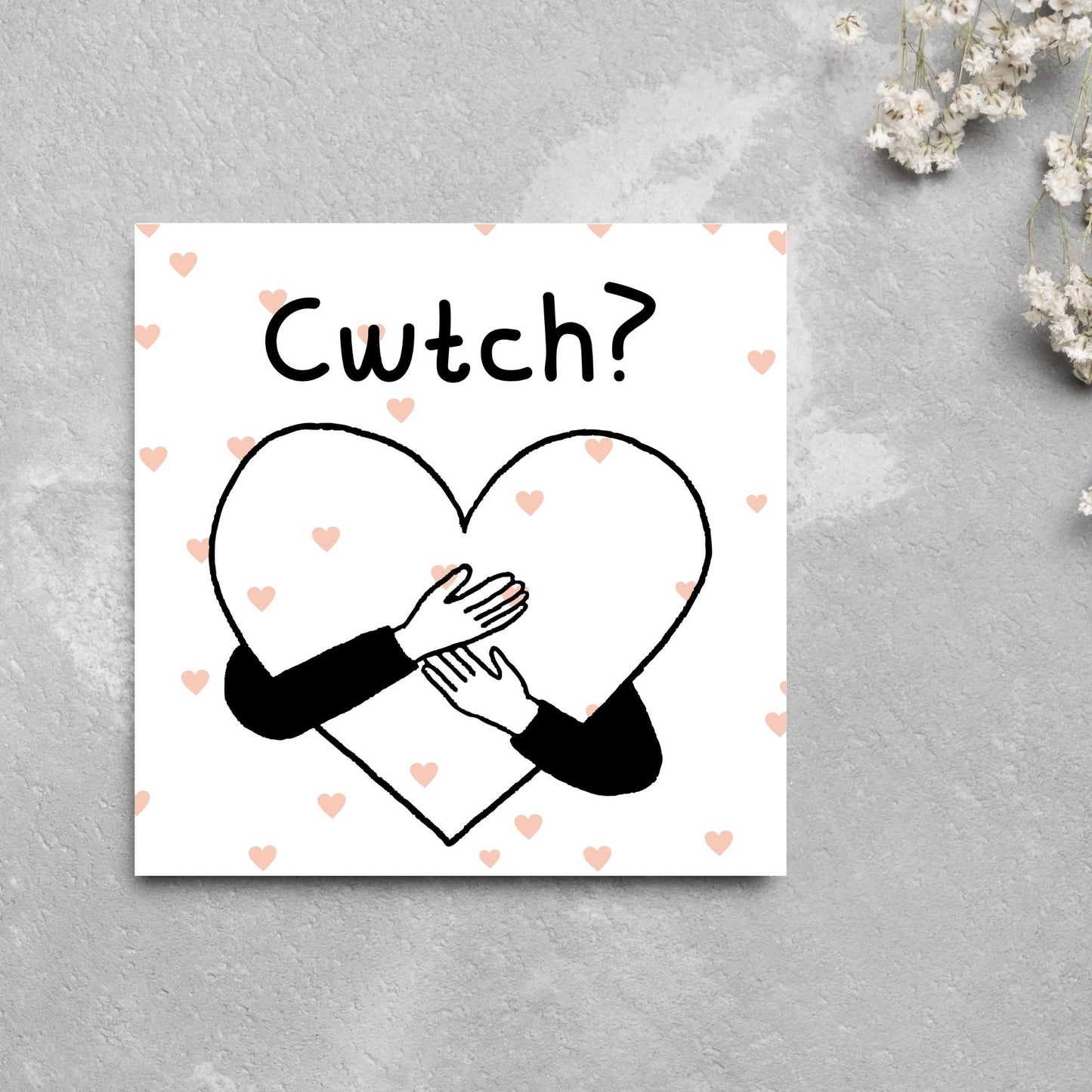 Square Greeting card small with subtle pink hearts in the background of a line drawn heart with hands hugging it and the word CWTCH? above it in handwritten style text