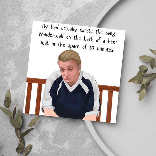 square card with a hand drawn image of kerry from this country sitting on a bench with handwritten style text above - My Dad actually wrote the song Wonderwall on the back of a beer mat in the space of 10 minutes